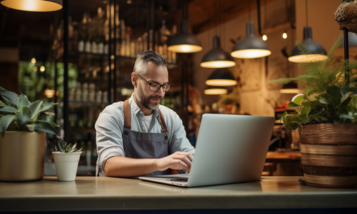 middle aged man wearing overalls in a coffeeshop